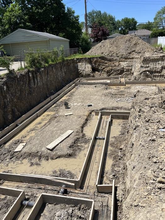 Excavated basement with poured concrete footings for a new home build in Metro Detroit
