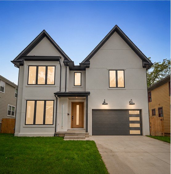 Completed custom home with gabled facade, black windows and finished landscaping built by ExquisiteHaus in Metro Detroit